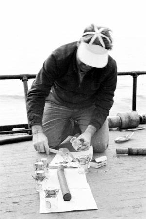 David Quentin Anderson, a bacteriologist, examining core sample aboard R/V Scripps