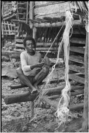 Mogiovyeka, smoking cigarette and making a fishing net