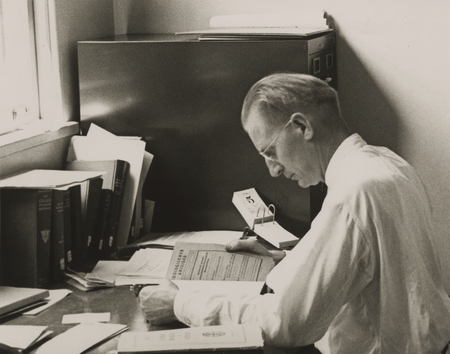 [Martin W. Johnson seated at his desk, Scripps Institution of Oceanography]