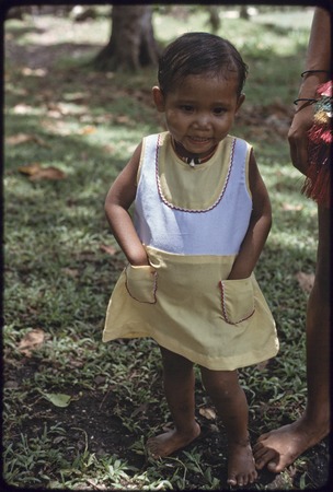 Young girl wearing cloth dress and shell necklace