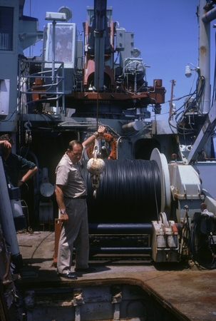 Captain Arsenault directing crane in hold onboard R/V Thomas Washington, Indopac Expedition. September 6, 1976