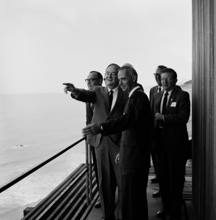 Vice President Hubert Horatio Humphrey visits the Scripps Institution of Oceanography campus, pointing along the coastline...