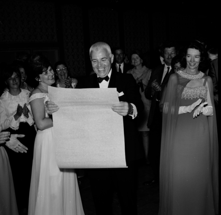 Chancellor William J. McGill with scroll at the UC San Diego Faculty Ball