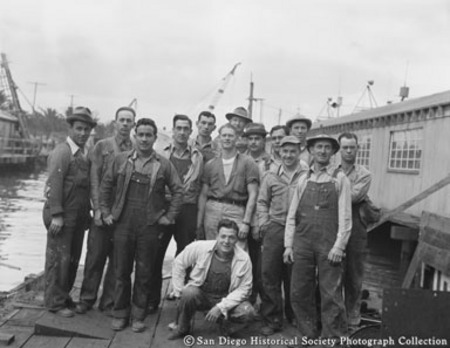 Crew of tuna boat Mary Lou posiing on dock