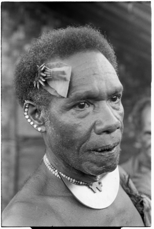 Man with dafi pearshell neck ornament, and plaited fari (spilt) comb with kwaloi&#39;a porpoise tooth star, and leaf bespelled...