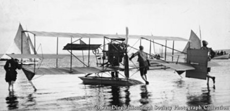 Pushing Curtiss hydroplane from beach into water