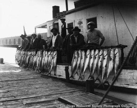 Group of men posing with catch on fishing boat Ramona