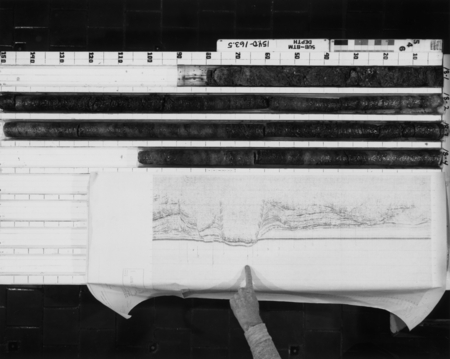 Split cores from the Deep Sea Drilling Project aboard the D/V Glomar Challenger (ship) along with a chart showing exactly ...