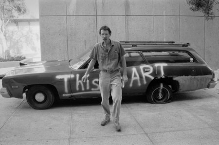 Visual Arts graduate student Jim Tittle and painted car in the Mandeville courtyard