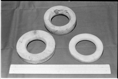 Three shell ring valuables, shown with ruler for scale