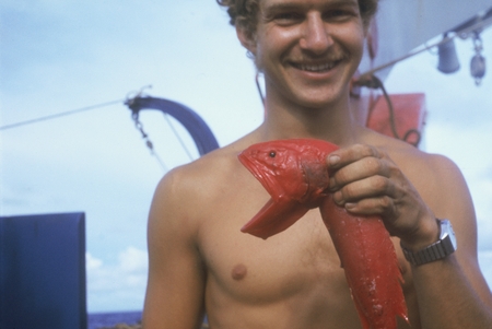 Robert Kieckhefer holding whalefish (Barbourisia rufa) in midwater trawl, Indopac Expedition. August 3, 1976