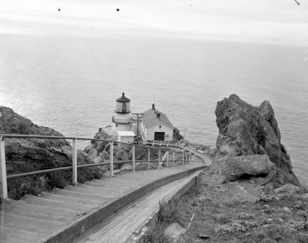 View down steps to lighthouse, and then back at light with shades drawn to protect frexnel lens from damage by the afterno...