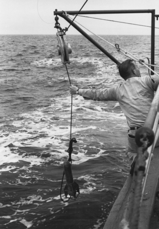 Retrieving bathythermograph Mech-I-Tron HY-Tech onboard CREST. February 1959