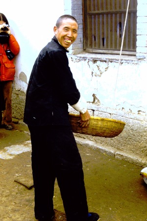 Chinese herbalist holding a bamboo basket (2 of 2)