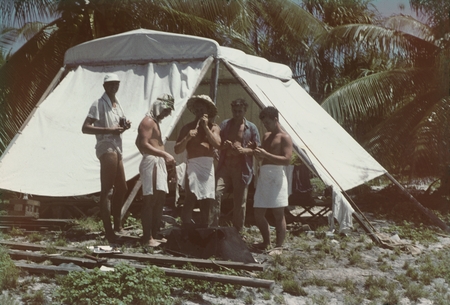 Shore party of unidentified crew members at the Bikini Atoll encampment, during the MidPac Expedition (1950). 1950.