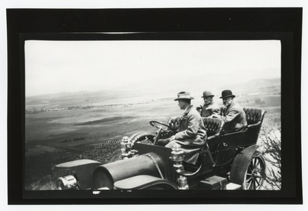 Men in car overlooking valley