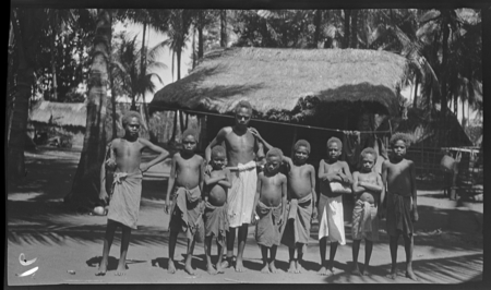 Man and boys in village; Matupit, New Britain