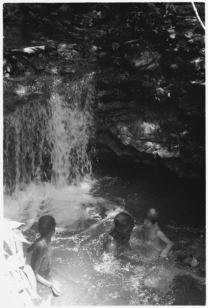 Keesing&#39;s children and others in pool of water, waterfall.