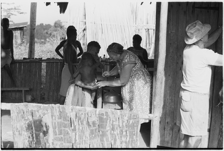 Wanuma: Lutheran missionary, Hildegard Schoettler, gives medical treatment to child