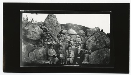 Women seated among boulders on Mount Helix