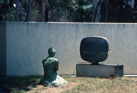 Something Pacific: detail: bronze buddha contemplating old television set