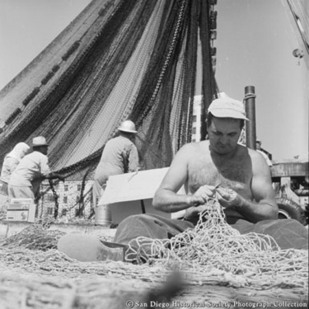 Man repairing fishing nets on Embarcadero