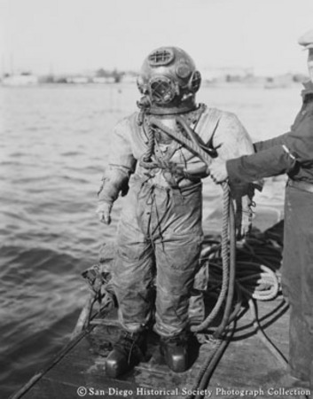 Woman deep sea diver preparing to enter San Diego Bay