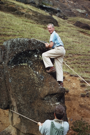 [Henry William Menard climbing Easter Island statue]