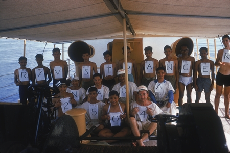Neptune Party with R/V Stranger crew holding signs &quot;R/V Stranger Naga 2504&quot; Naga Expedition, December 1960