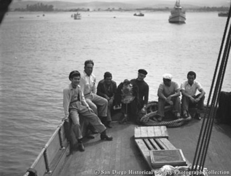 Men sitting on deck of American Agar Company boat