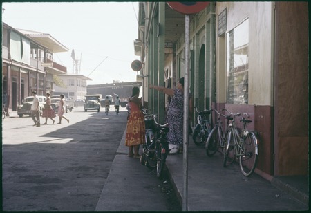 Papeete commercial district: street scene, cargo ship in port