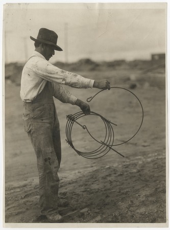 Unidentified man with reinforcement coil for the El Cajon pipeline