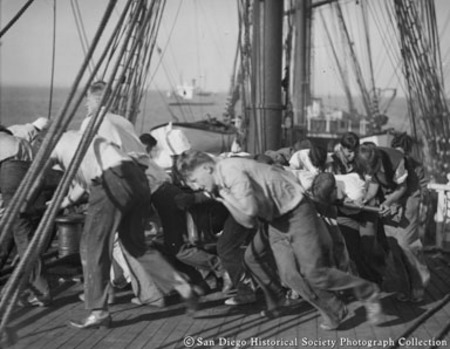 Crew working on deck of sailing ship Pacific Queen