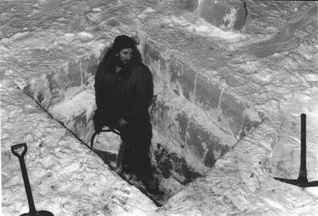 Paul Dayton Shoveling Out Ice And Snow While Cutting A Hole