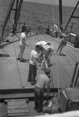 [Men with core barrel on deck of R/V Spencer F. Baird]