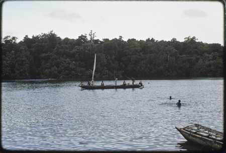 Fishing: canoe returning to inlet near Tukwaukwa, poled by men, children swim out to meet them