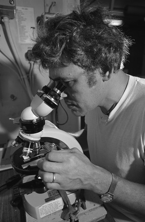 Deep Sea Drilling Project Leg 34, Manuel N. Bass with microscope. 1973
