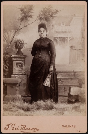 Photograph of an African American woman with a fan