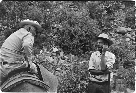 Tacho Arce, left, exchanging gossip with rancher at Rancho San Nicolás