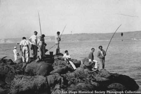 Chinese Americans fishing in San Diego Bay from rocks on North Island