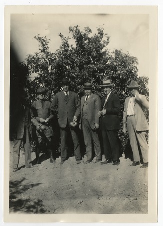Ed Fletcher with group of men in a citrus grove