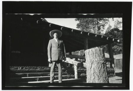 Ed Fletcher near rustic cabin