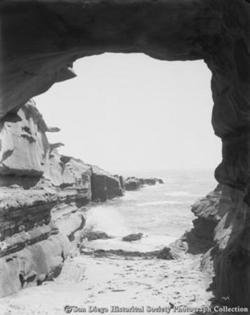 View of La Jolla Point and ocean through rock arch