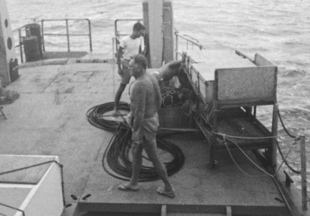 George W. Hohnhaus (foregrond) on R/V Horizon during Nova Expedition, putting the magnetometer fish into the water and pay...