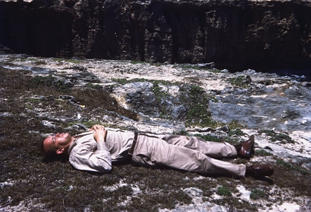 Russell Raitt lying on a lava flow in Oahu
