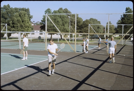 Students playing tennis on Matthews campus tennis courts