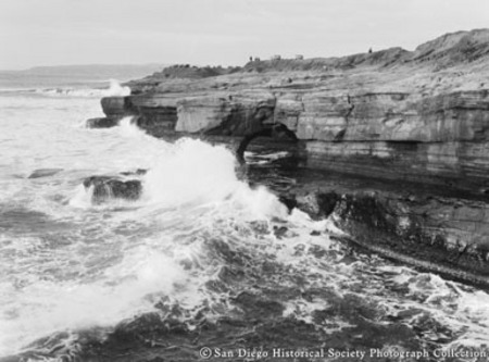 Ocean waves, cliffs, and rock arch on Sunset Cliffs coast
