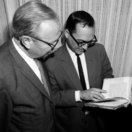 Melvin Voigt and Ronald Silveira with rare book