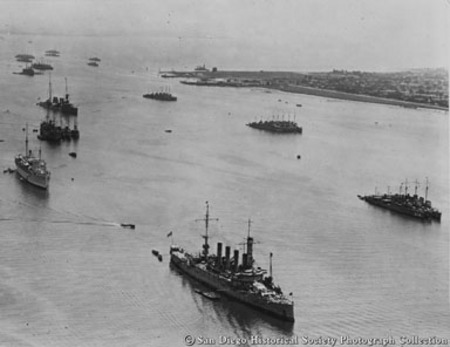 Aerial view of U.S. Navy ships entering San Diego Bay