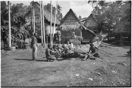 Canoe-building: men gathered to work on canoe